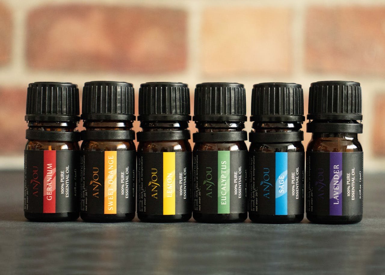 A close-up of six essential oil bottles for aromatherapy use.