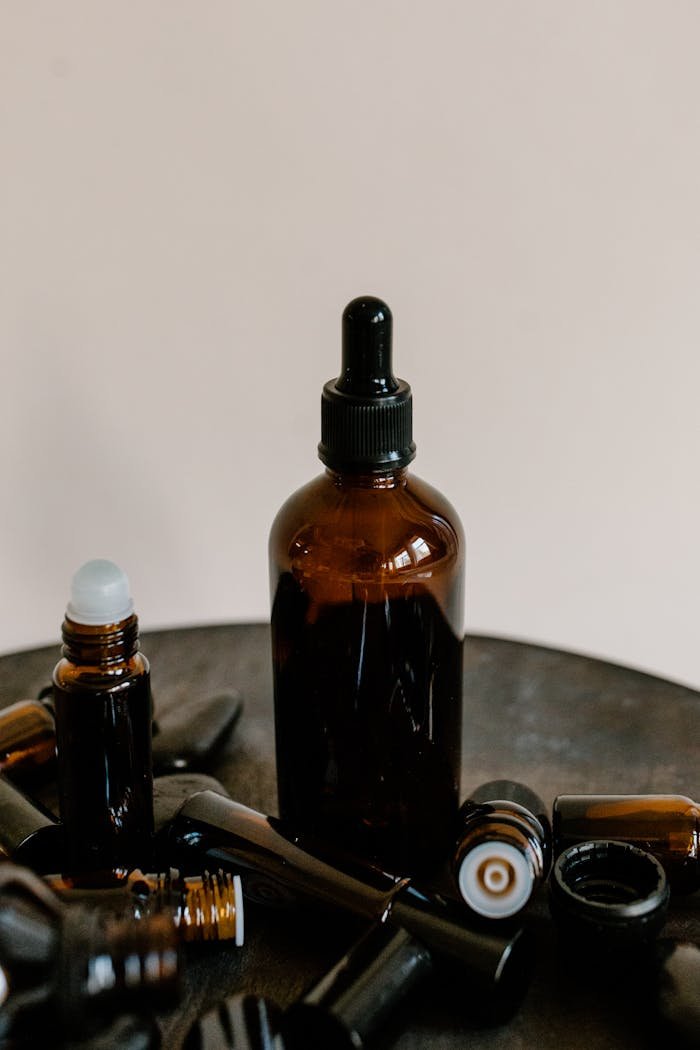 Dark glass bottles with droppers for essential oils, ideal for aromatherapy and wellness