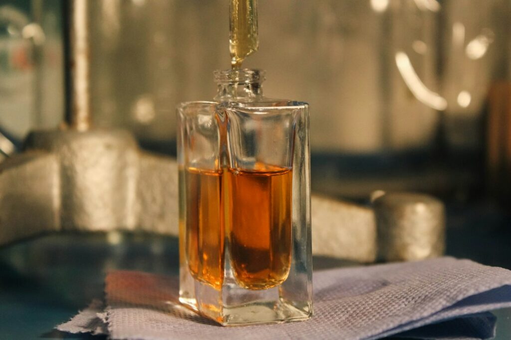 Musk in Perfume: Natural vs White Musk Explained Perfume oil being poured into a glass