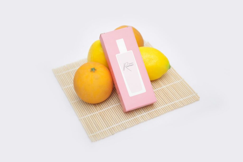 Lemons and oranges on a wooden table, the fresh citrus notes of summer scents